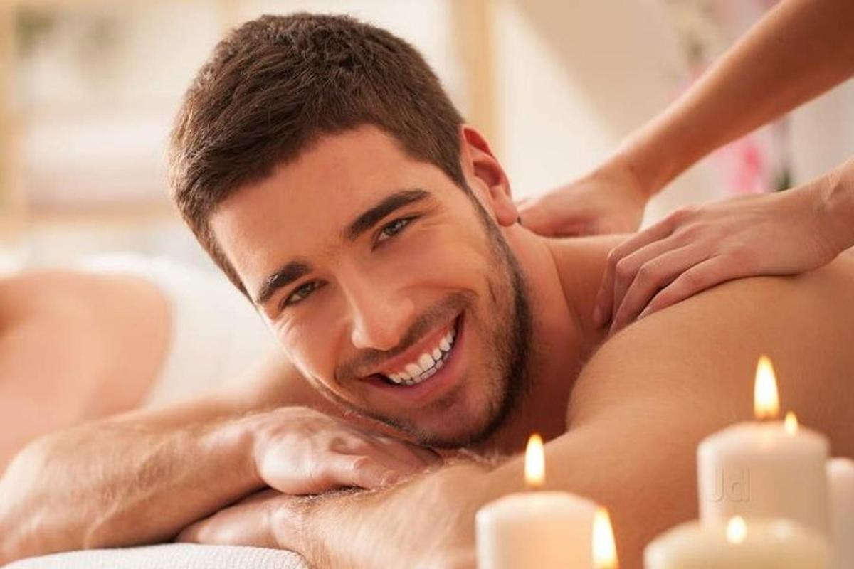 a man getting a massage in a spa with candles