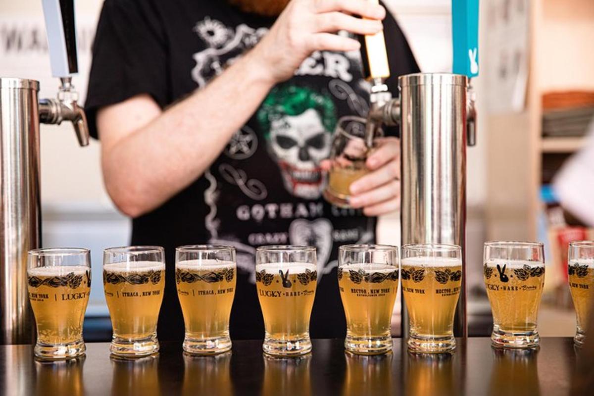 a group of glasses of beer on a bar