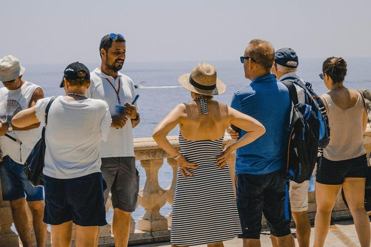a group of people standing next to the ocean