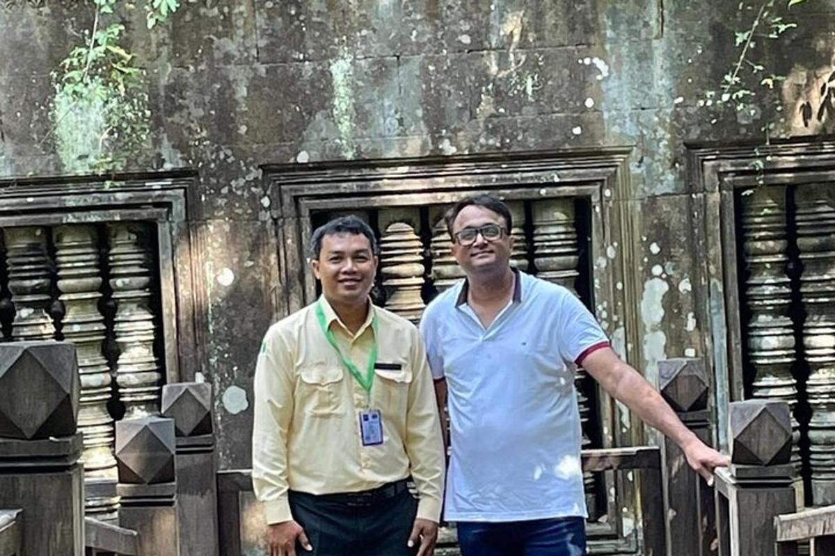 two men are standing in front of a building