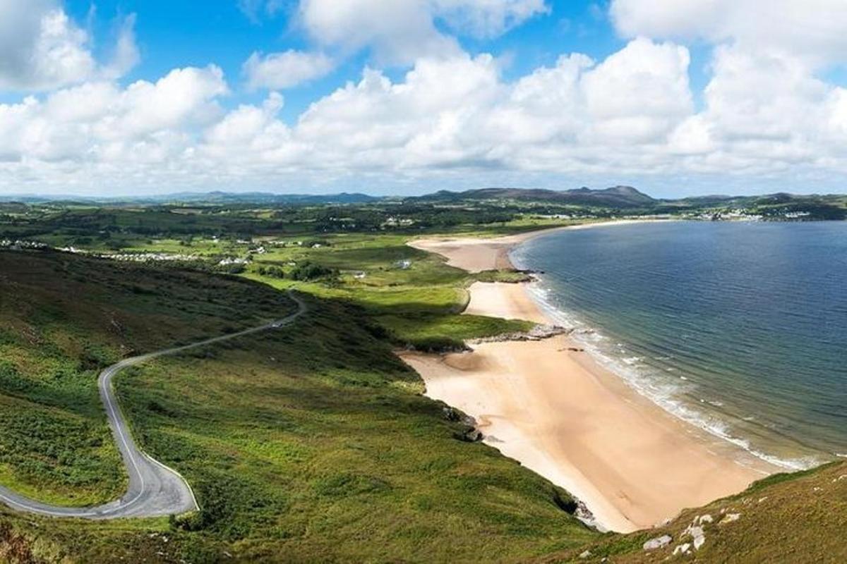 a view of a beach with a road next to the water