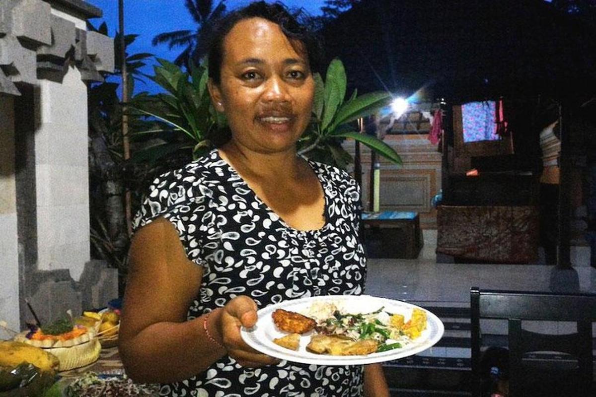 a woman is holding a plate of food