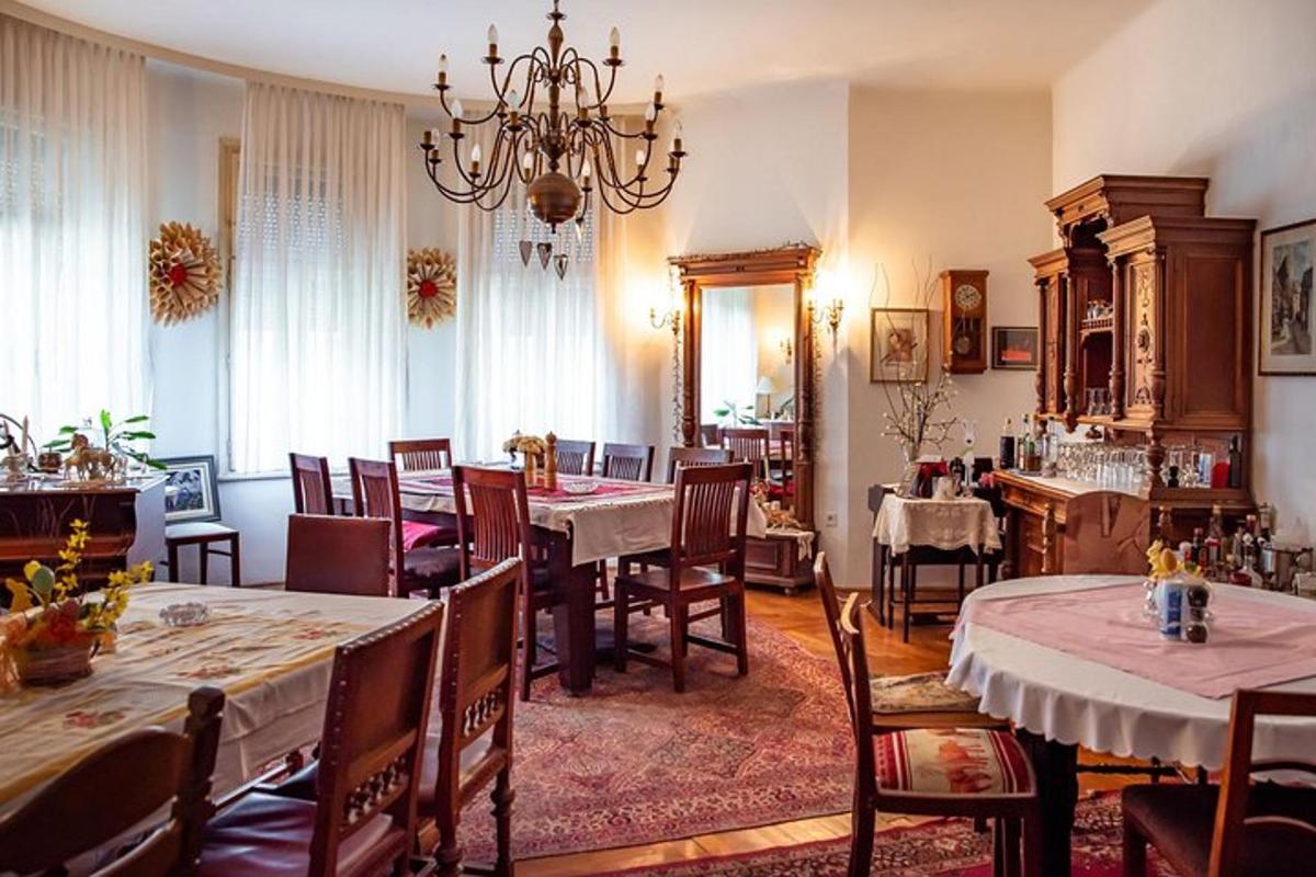 a dining room with tables and chairs and a chandelier