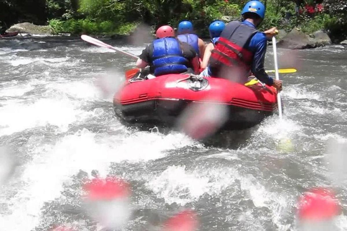a group of people in a raft in a river