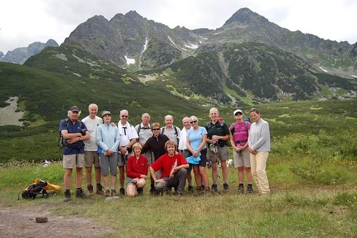 a group of people posing for a picture on a mountain