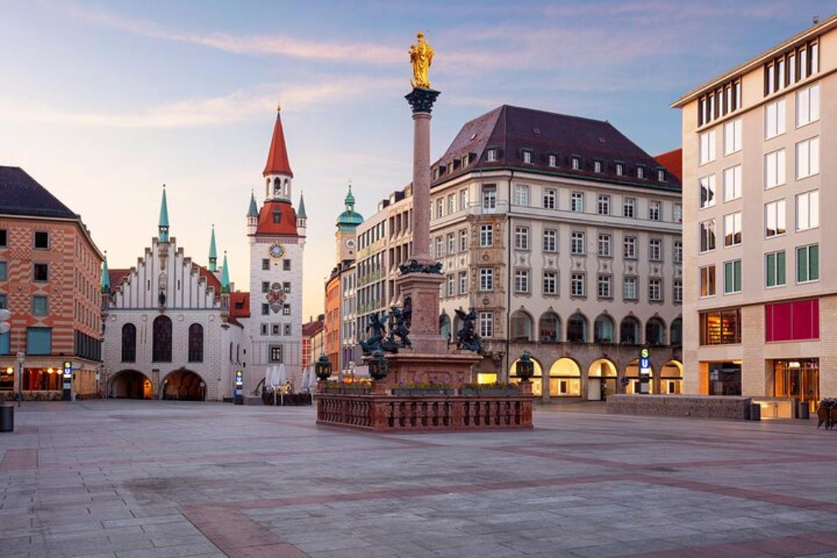 a city square with a statue in front of buildings