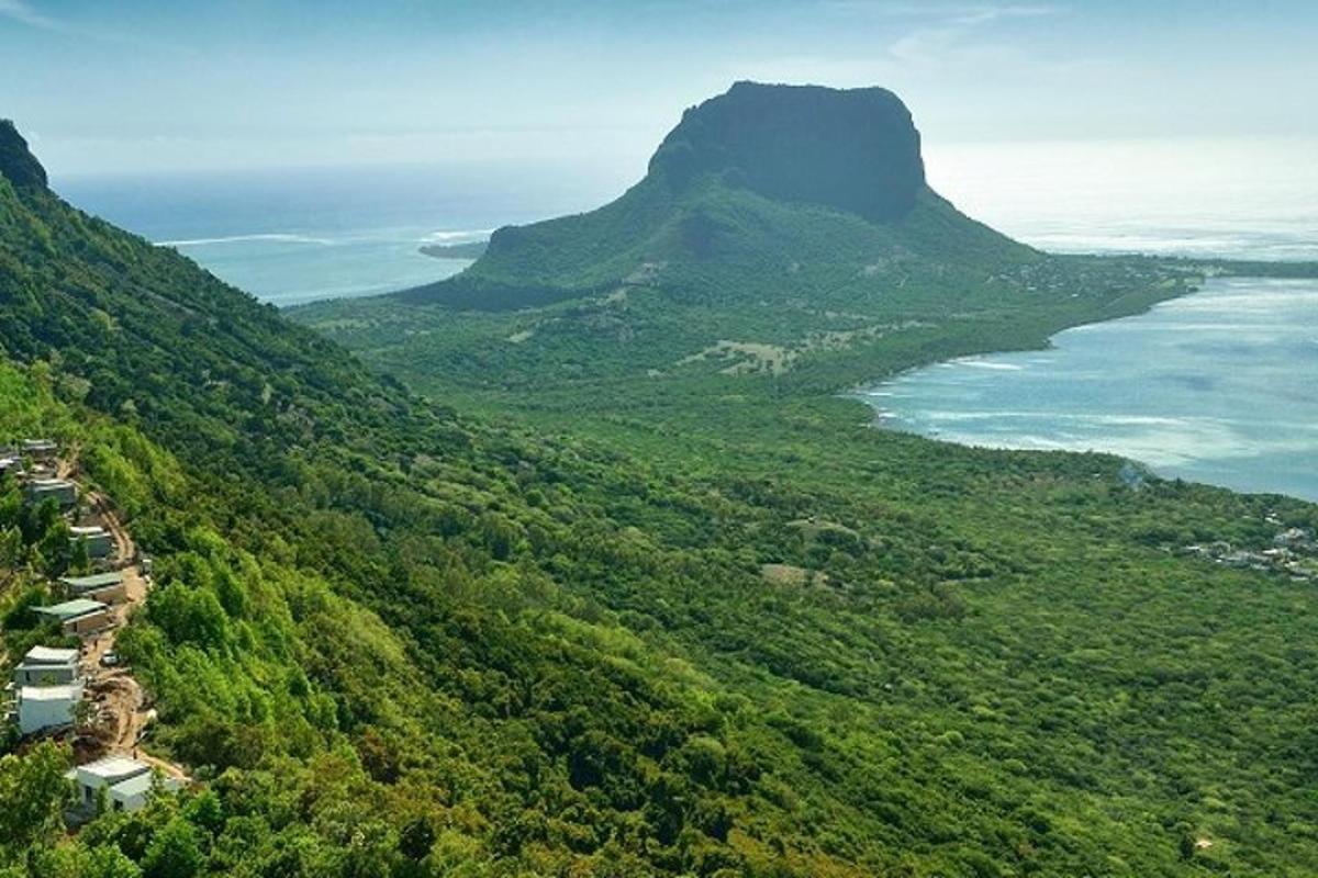 an aerial view of a mountain and the ocean