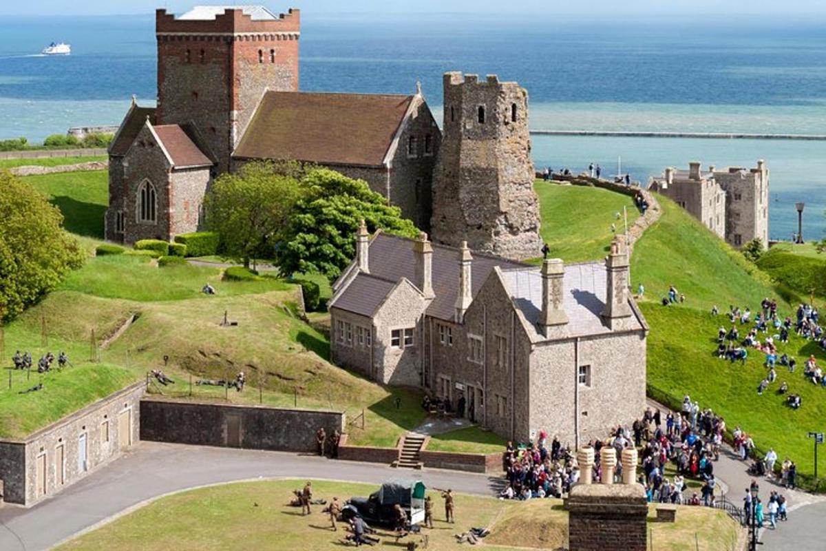 an old castle with a crowd of people standing outside it
