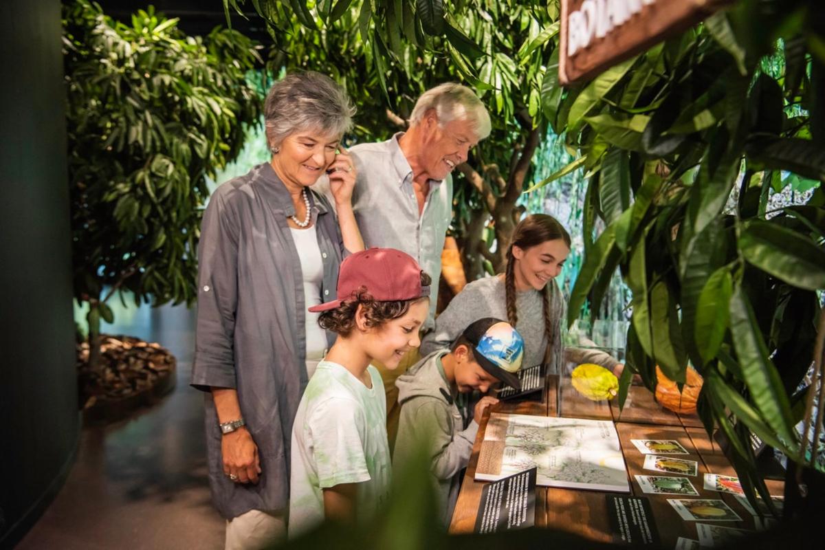 a group of people standing around a table