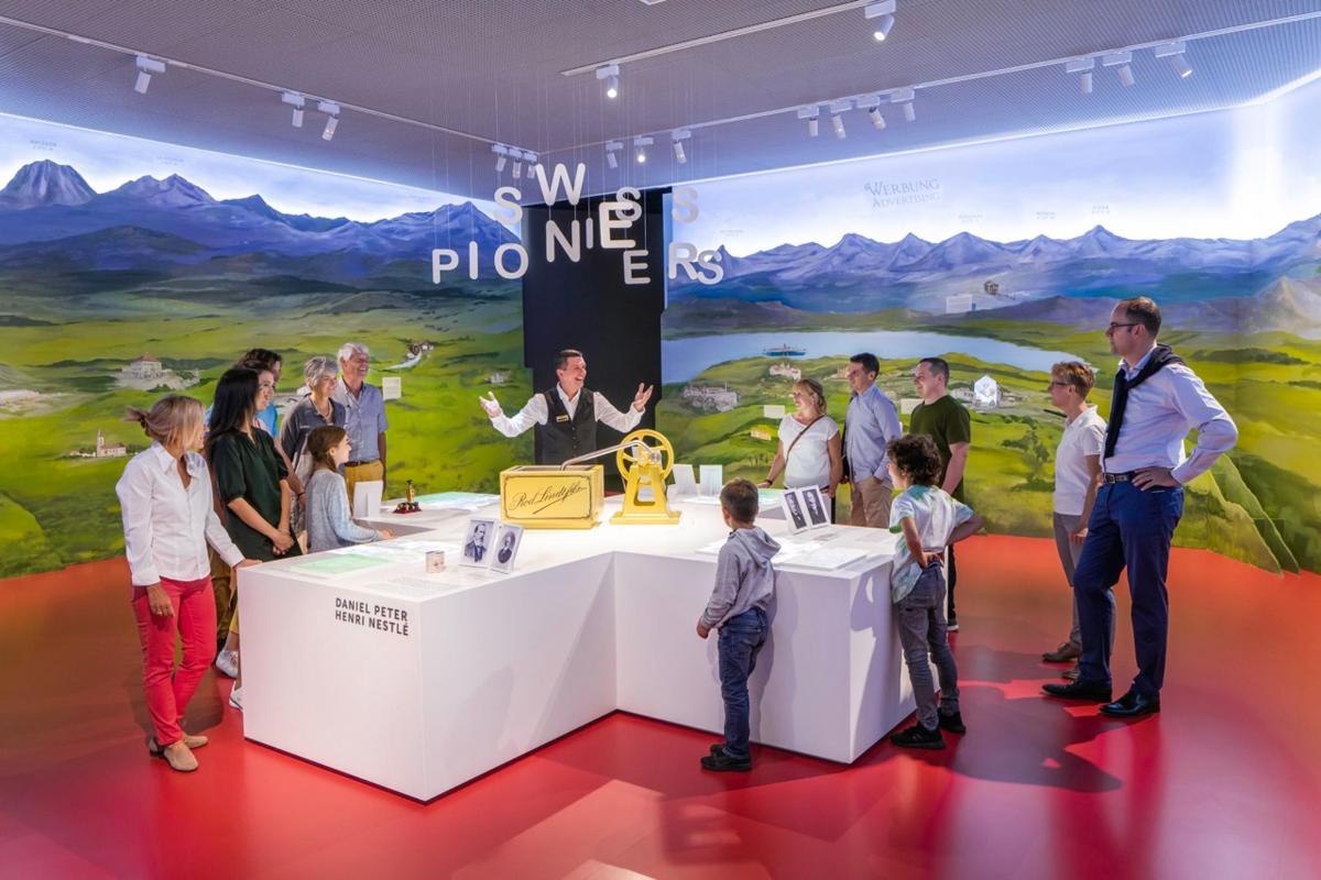 a group of people standing around a table in a show room