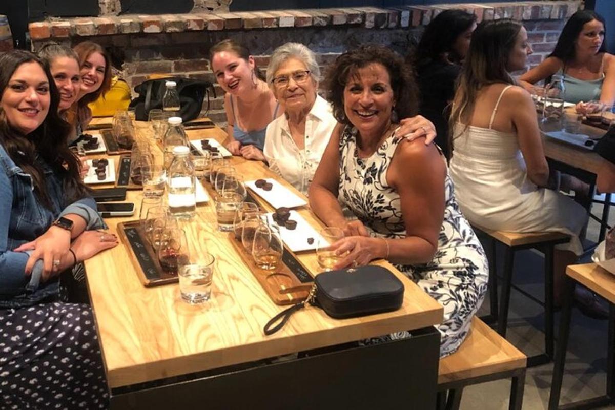 a group of people sitting around a table with wine glasses