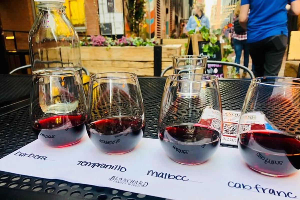 three glasses of red wine sitting on a table