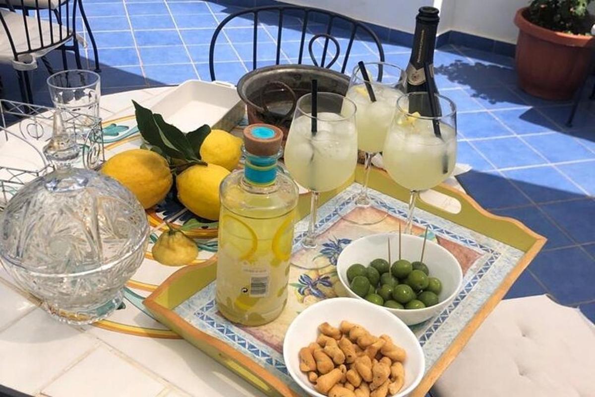 un tavolo con bicchieri di limonata e una ciotola di frutta