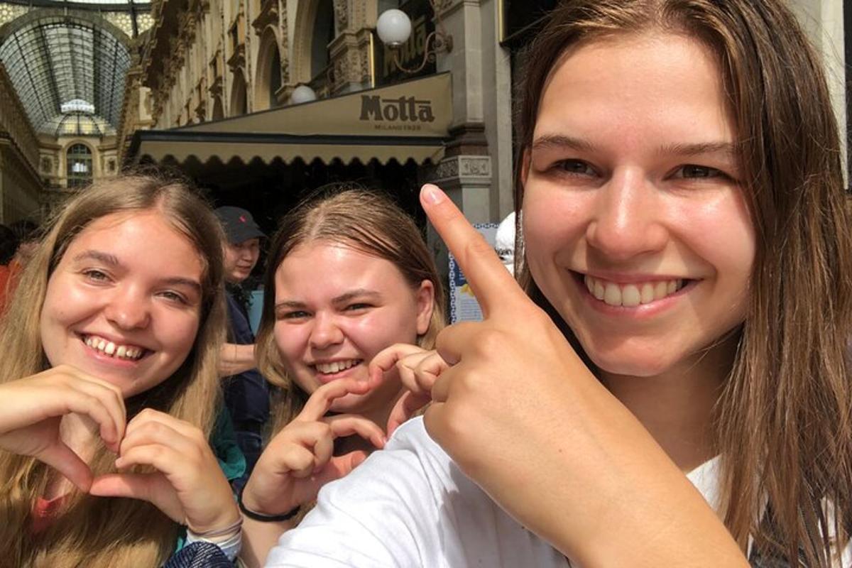 two girls making the peace sign with their hands