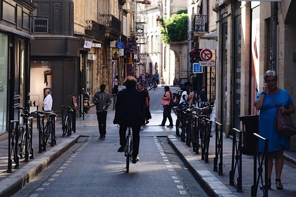 a man riding a bike down a city street
