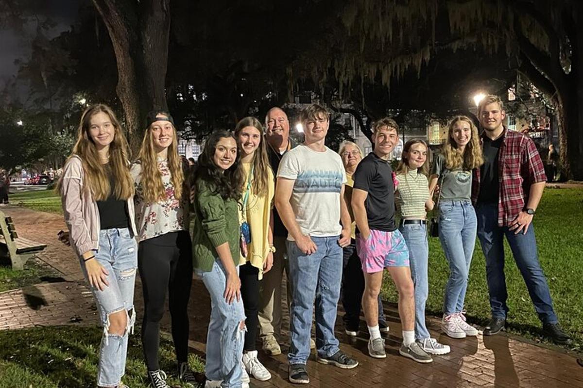 a group of people standing in a park at night