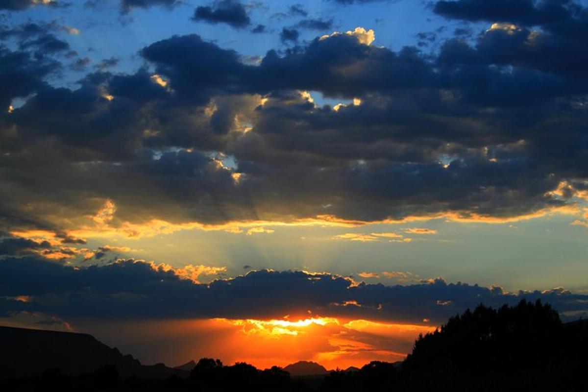 um céu nublado com o sol aparecendo por entre as nuvens