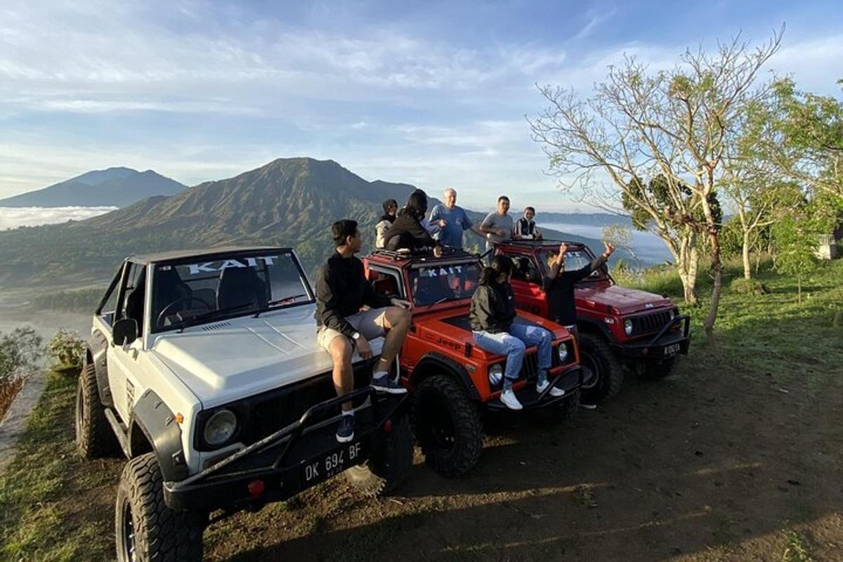 a group of people sitting on the back of a jeep