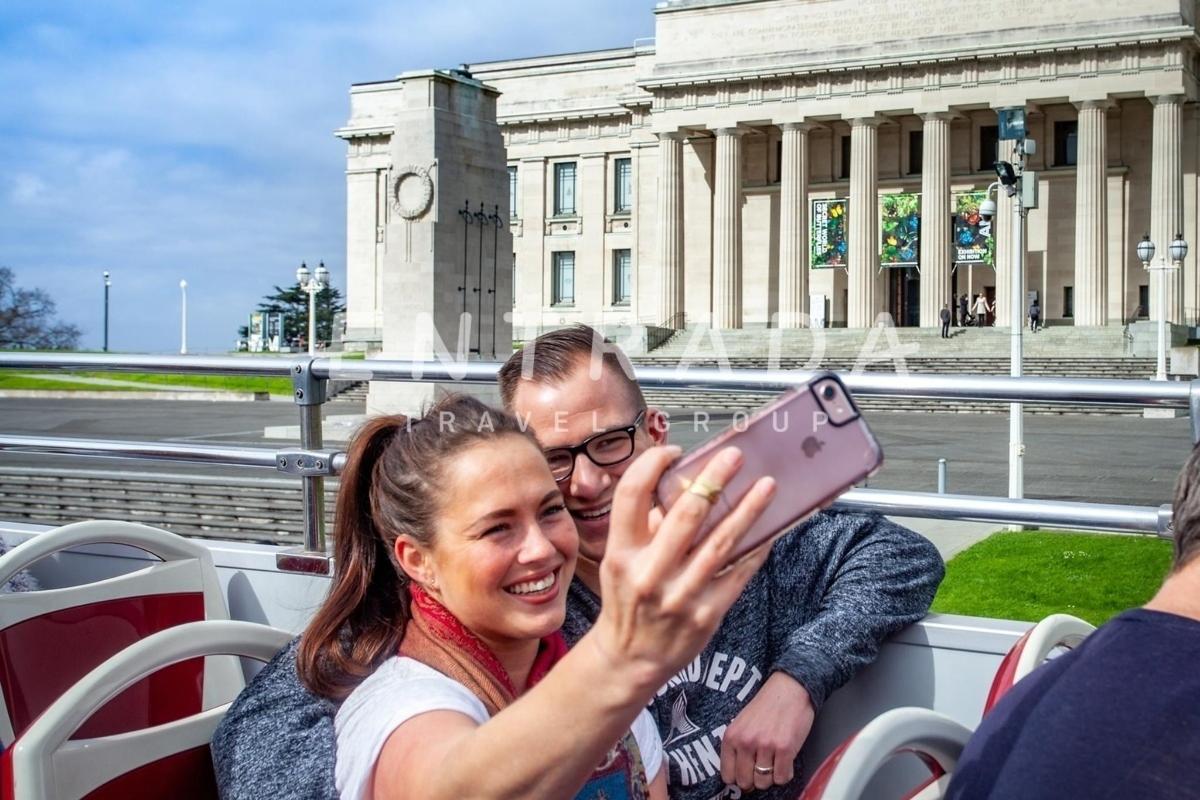 a man and a woman taking a picture with a cell phone