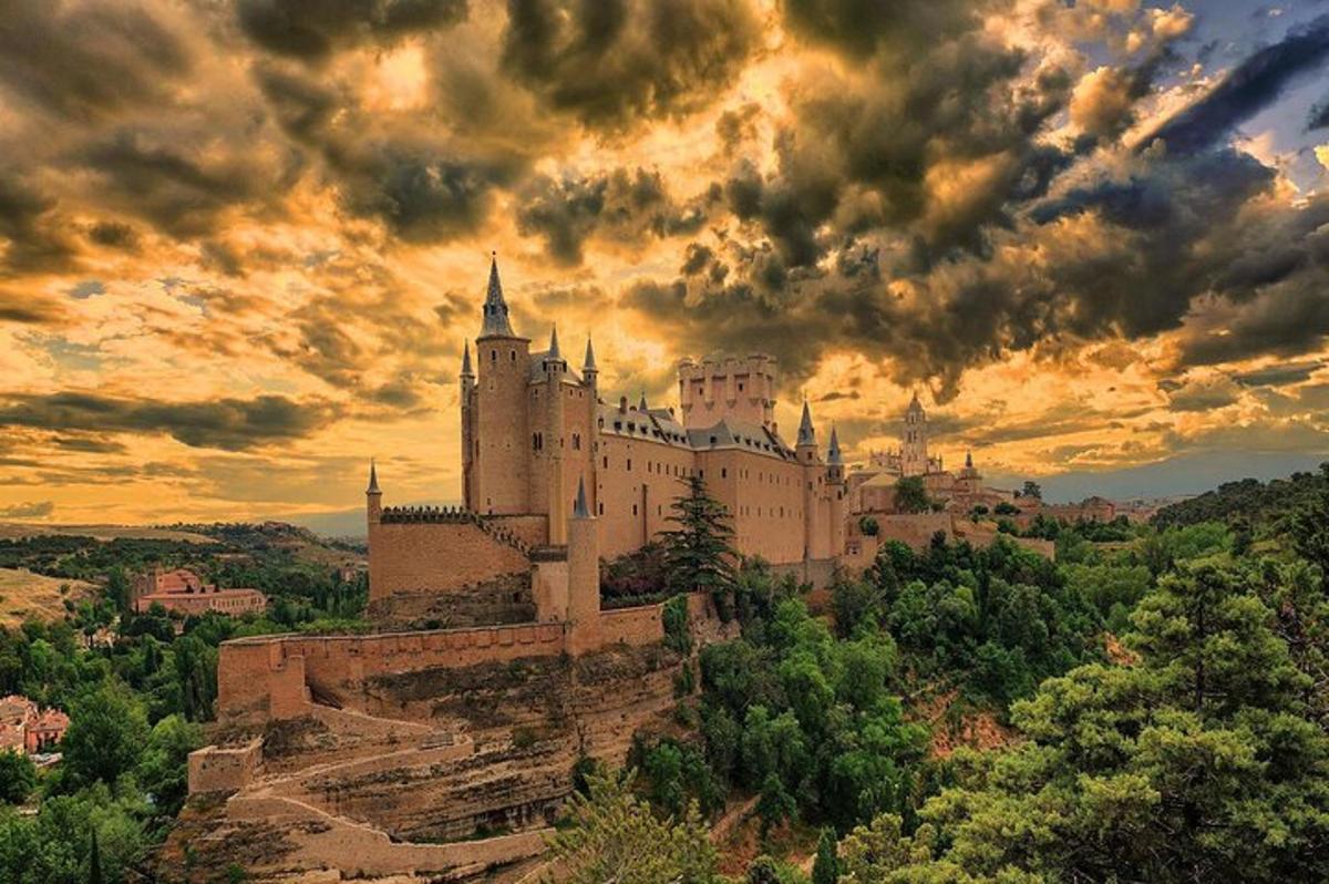 a castle on a hill with a cloudy sky