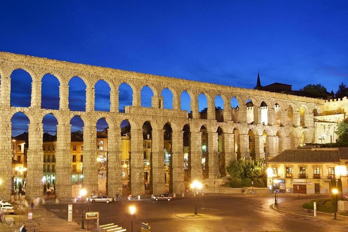 a large stone building with arches at night