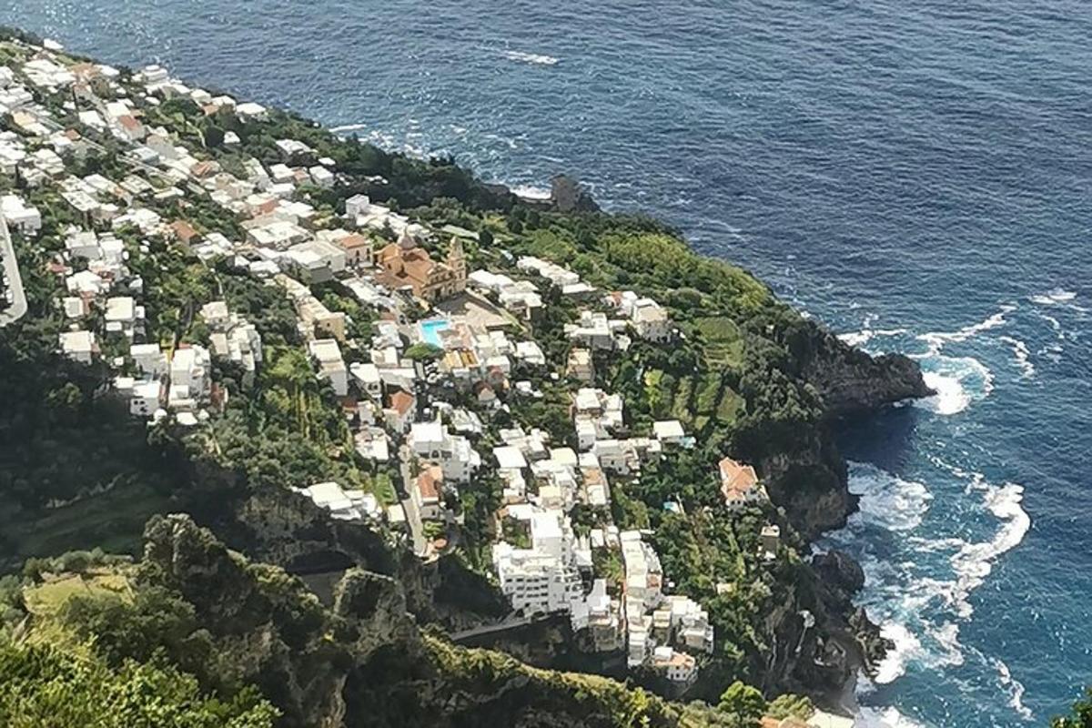 un gruppo di case su una montagna vicino all'oceano
