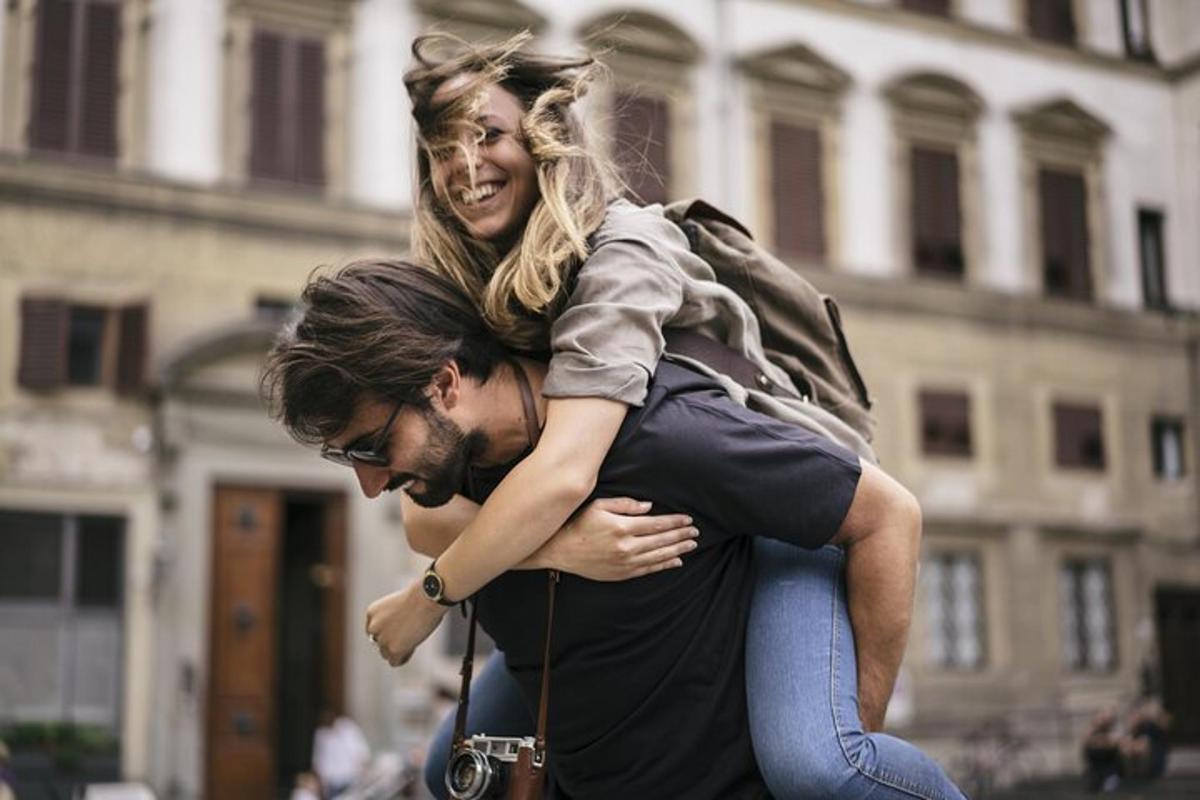 un hombre que lleva a una mujer sobre sus hombros