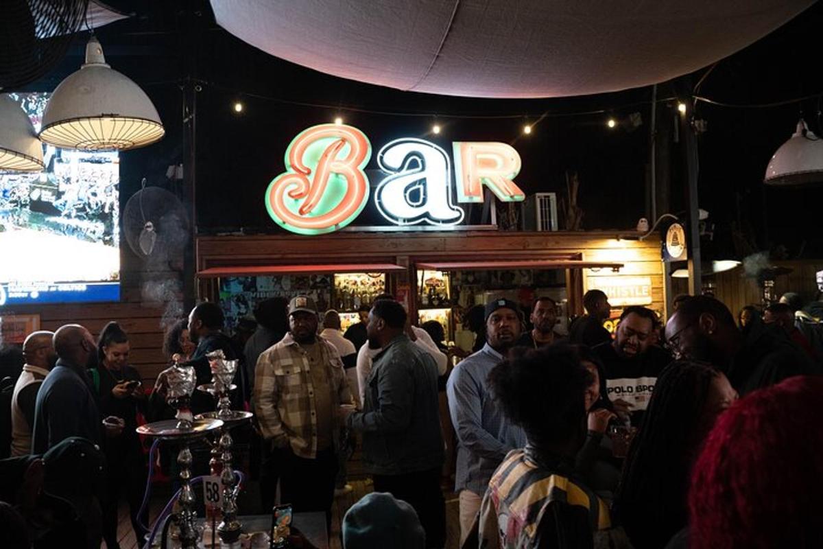 a group of people standing at a bar in a restaurant