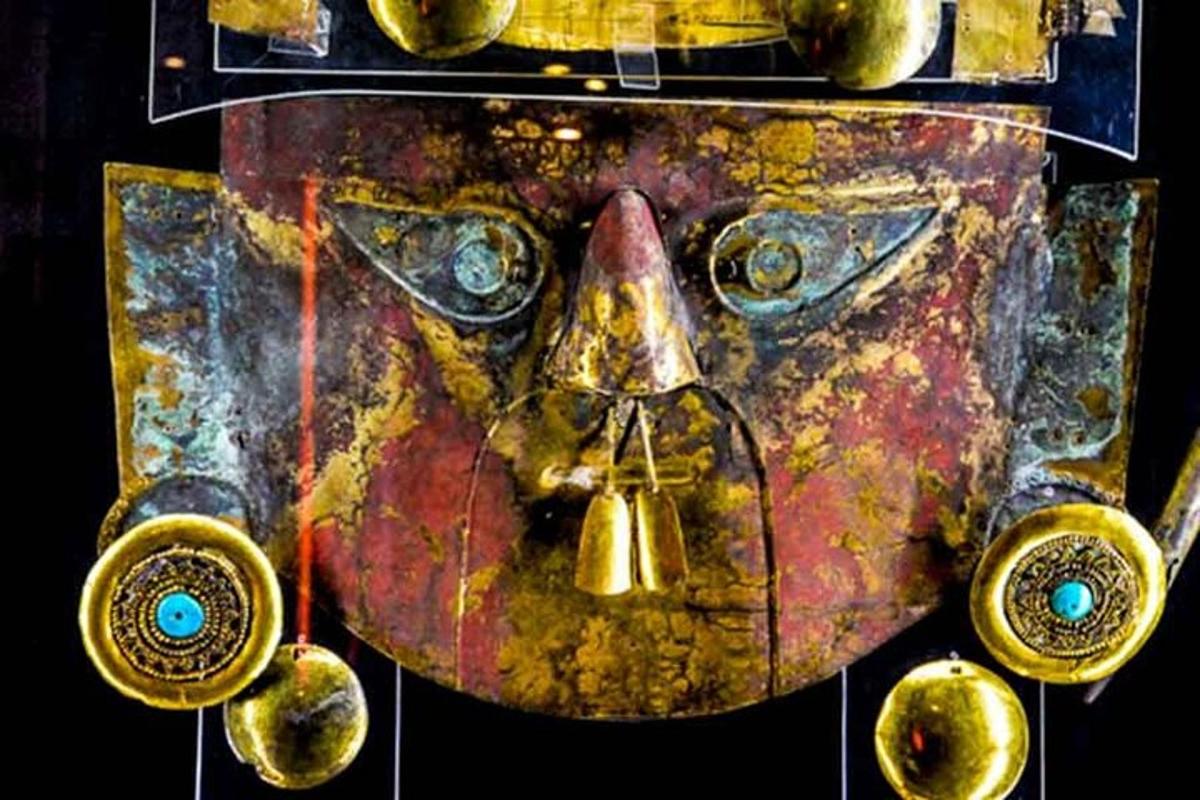 a painting of a statue of a face with bells