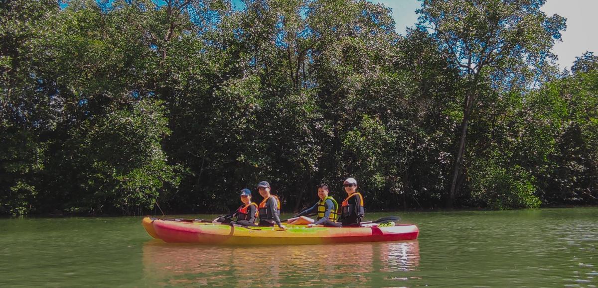 a group of people in a canoe on the water