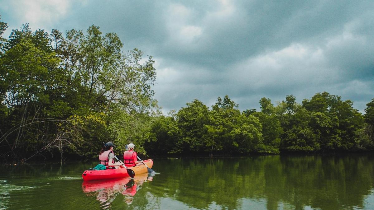 two people in a boat on a river