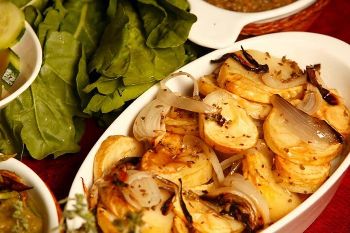 a white bowl of food on a table with lettuce