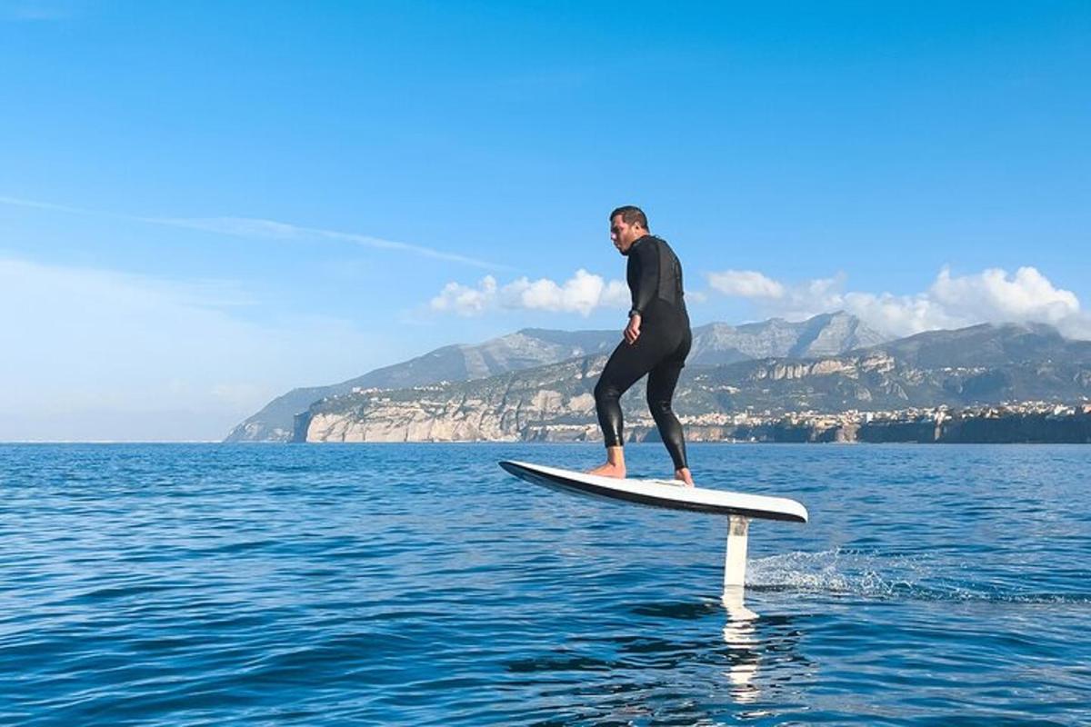 a man standing on a surfboard in the water
