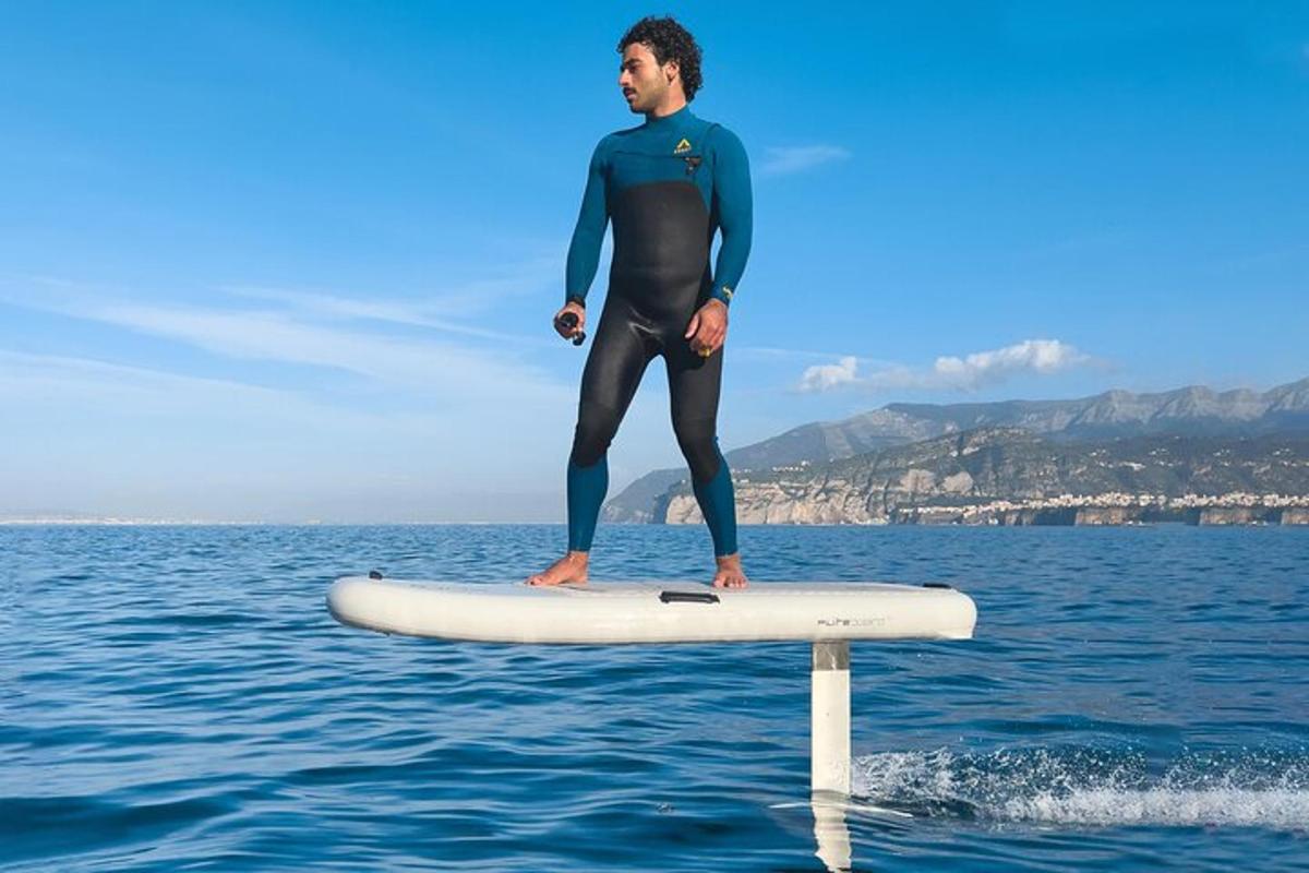 a man standing on a surfboard in the water