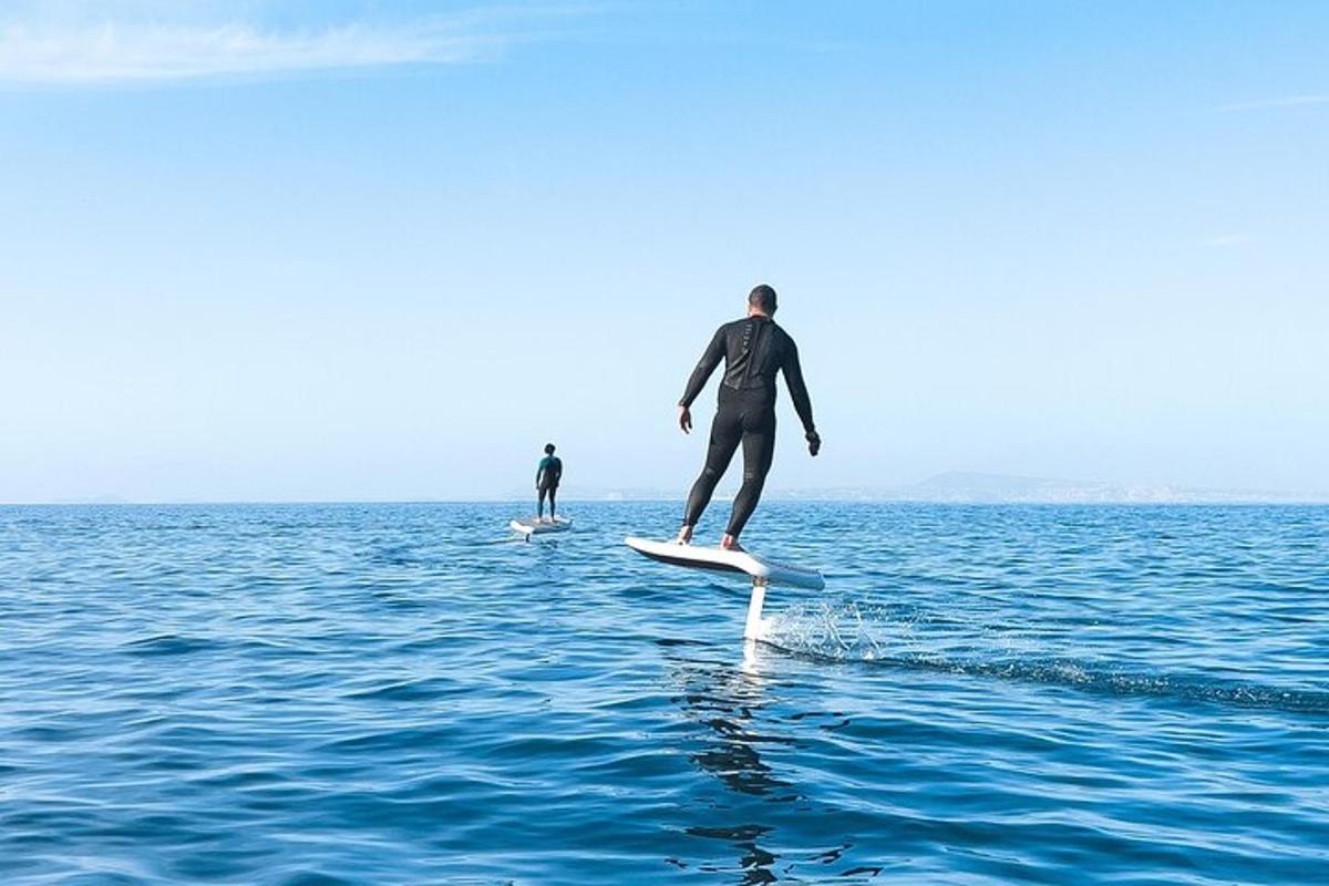 two people in the water on surfboards in the water