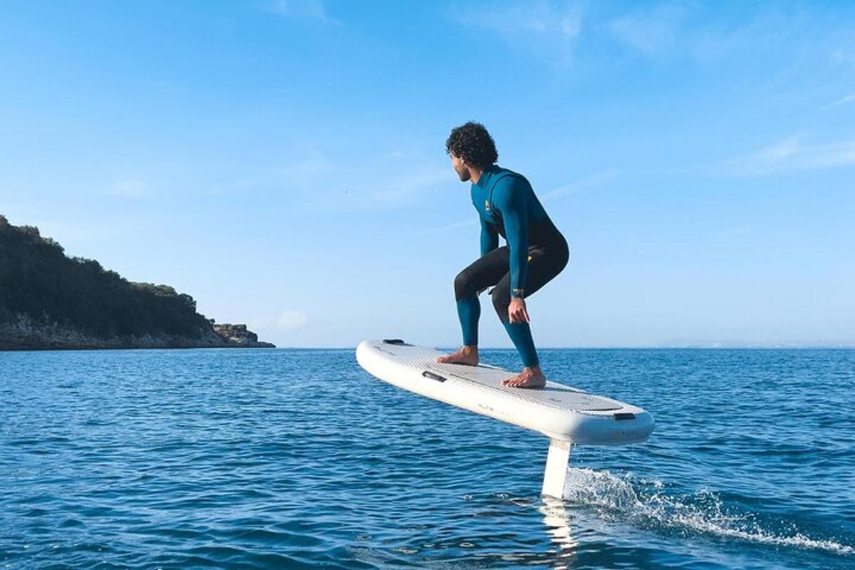 a man standing on a surfboard in the water