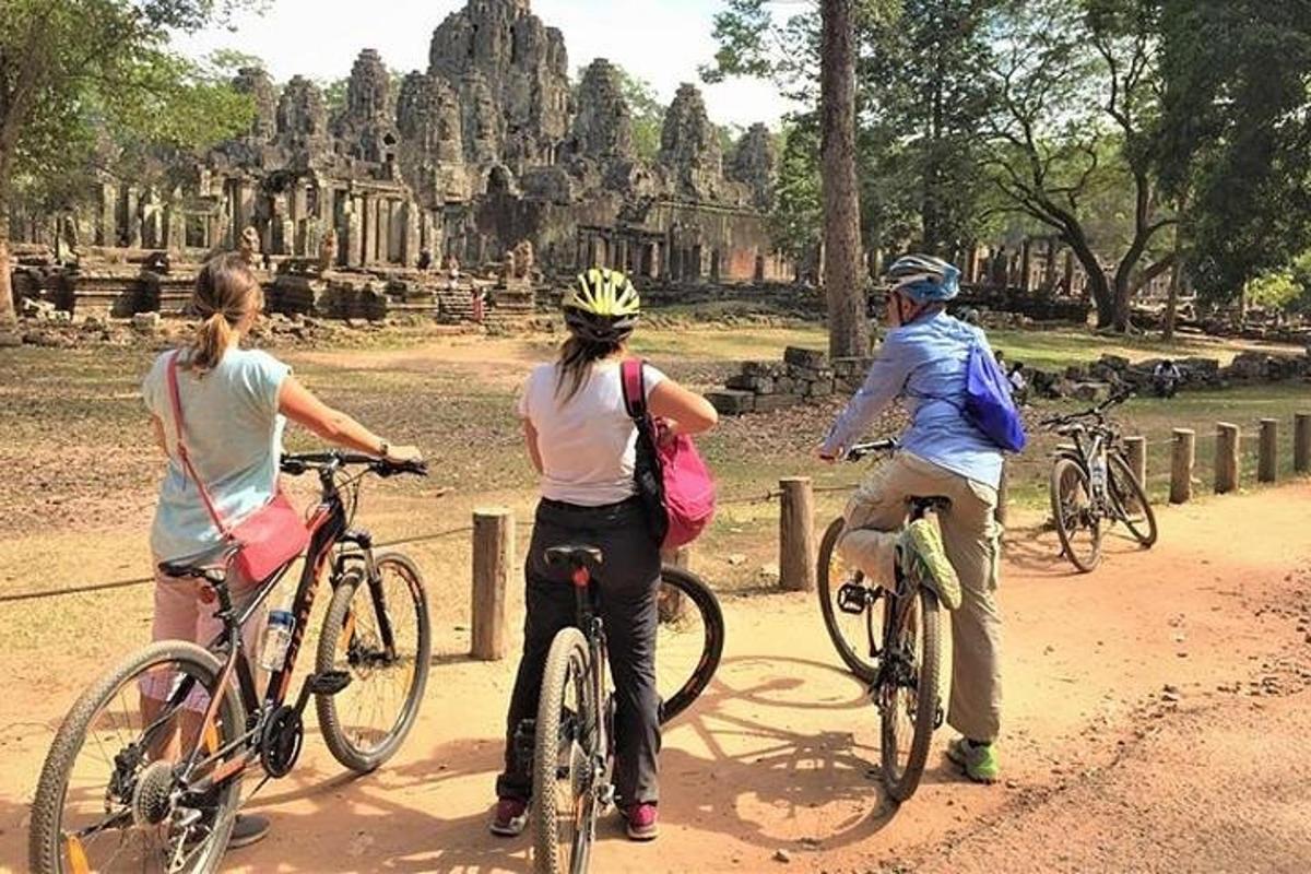 ba người đi xe đạp trước một ngôi đền