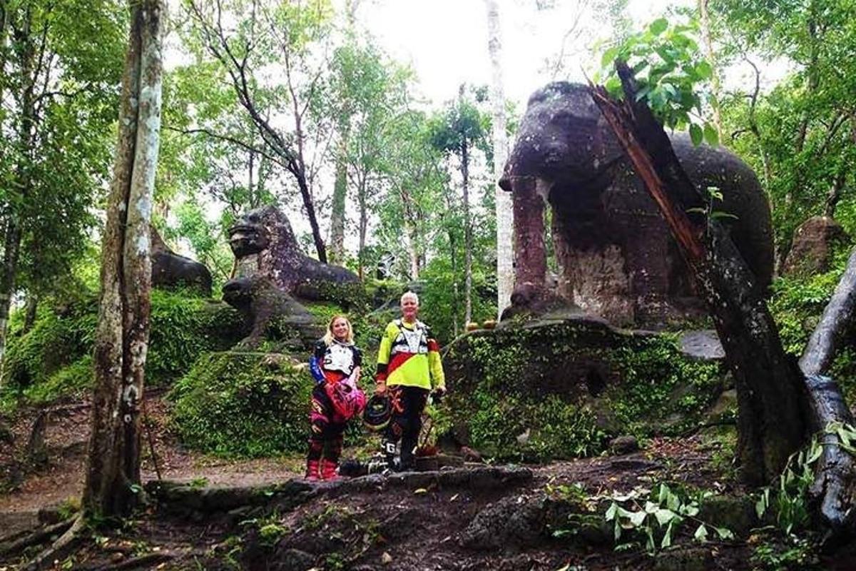 a man and two children standing in front of a statue