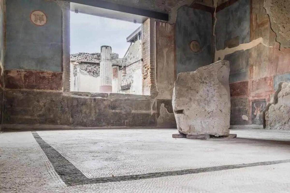 an empty room with a stone chair in a building