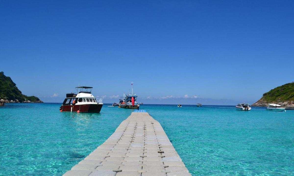 un doc în ocean cu bărci în apă