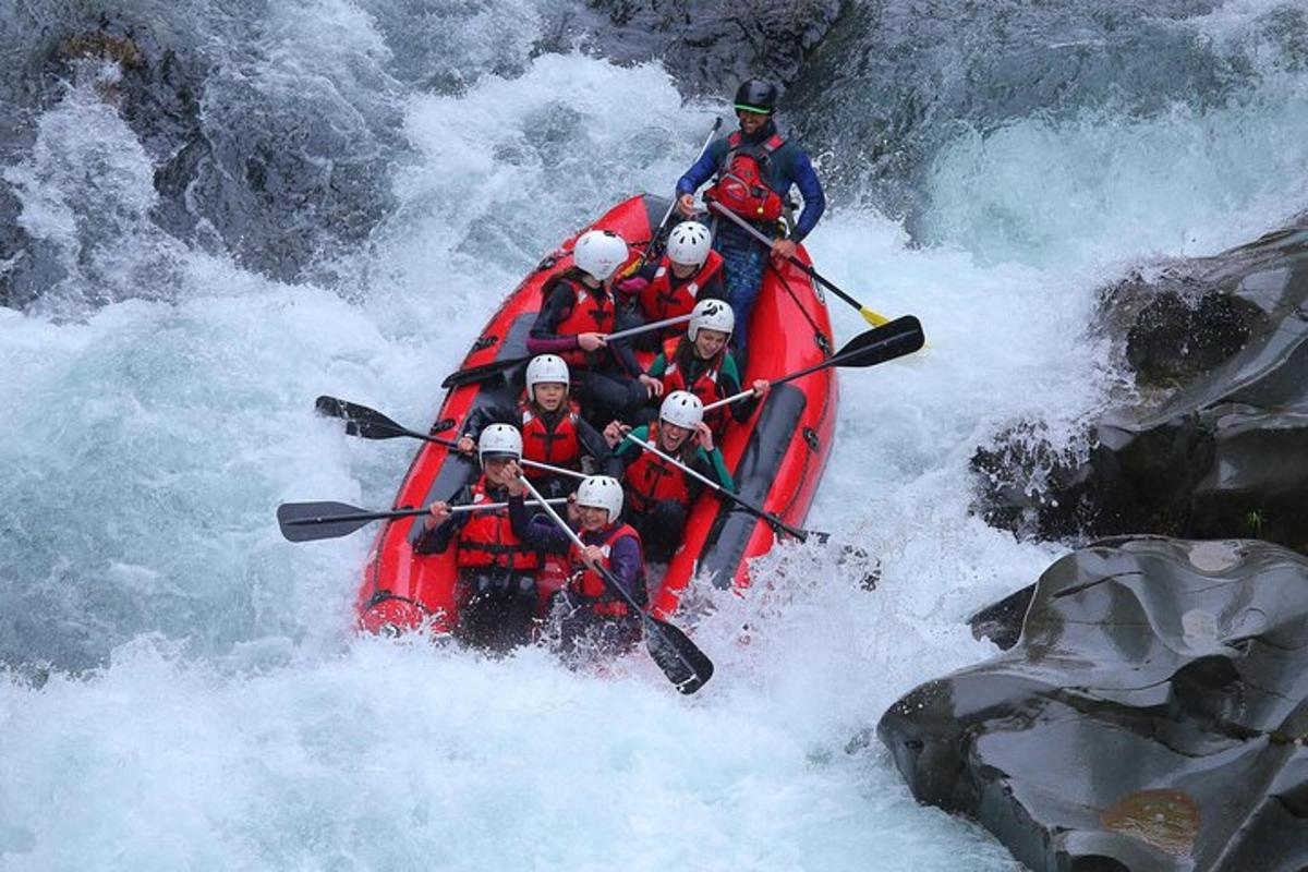 un gruppo di persone su una barca rossa su un fiume