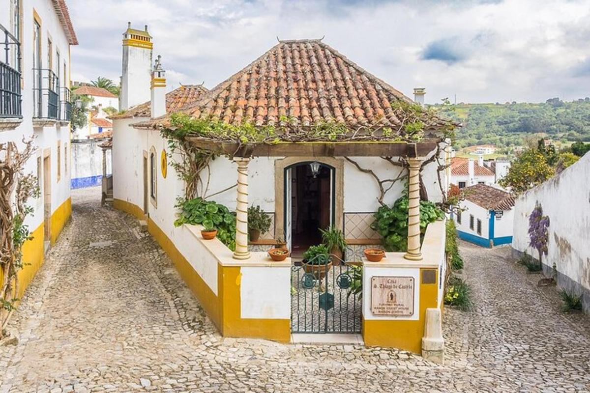 a small white building with a tile roof