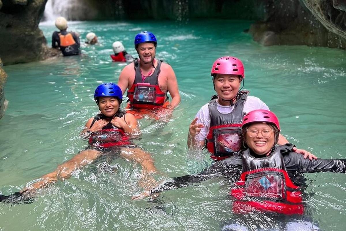 a group of people in the water wearing helmets