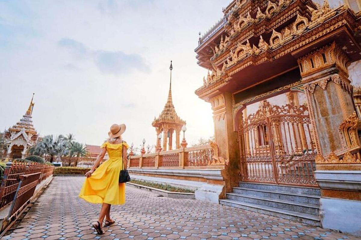 a woman in a yellow dress standing in front of a building