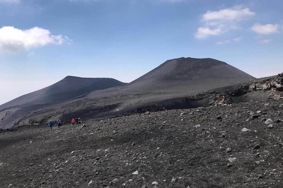 un gruppo di persone che camminano su una montagna rocciosa