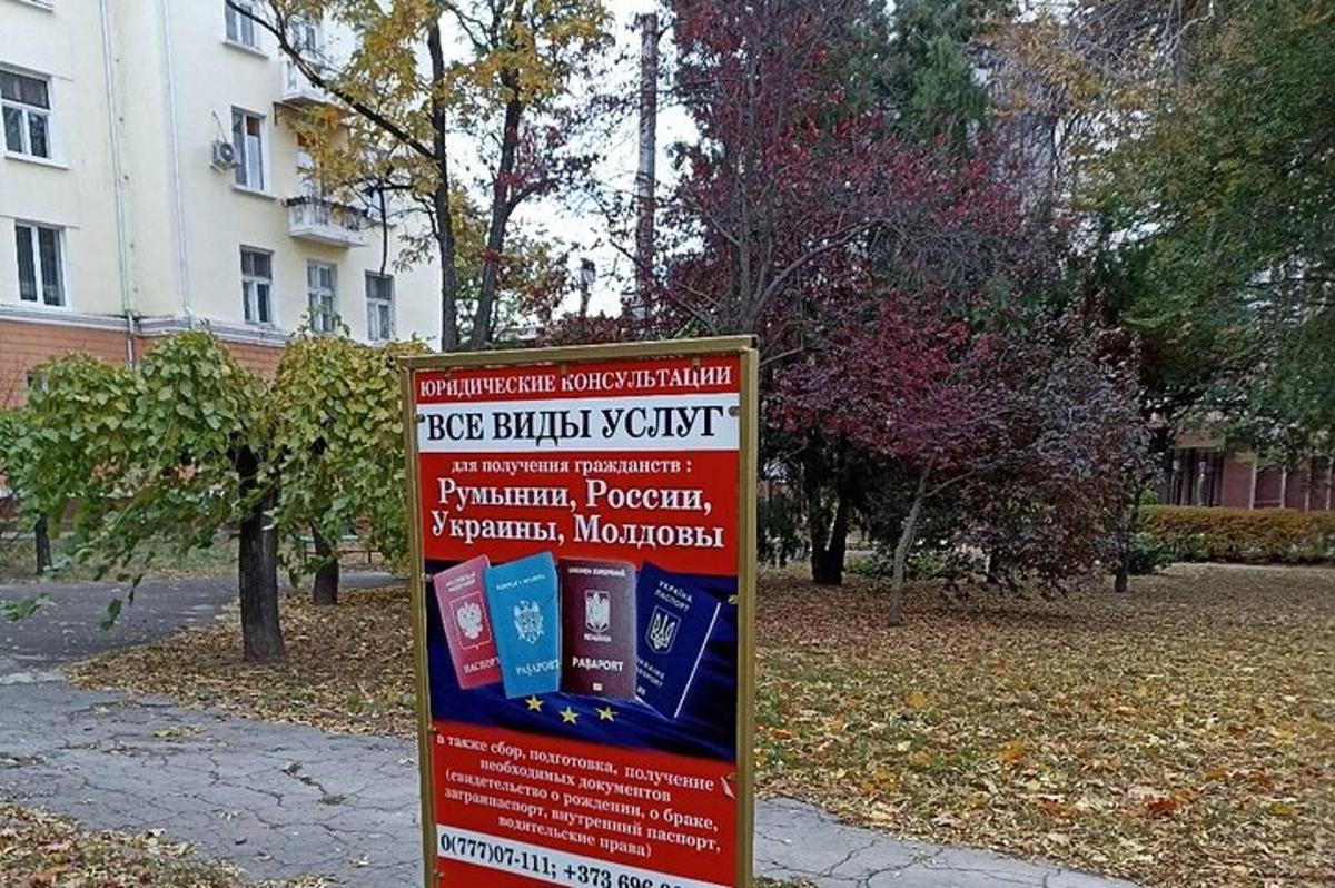 a sign in a park in front of a building