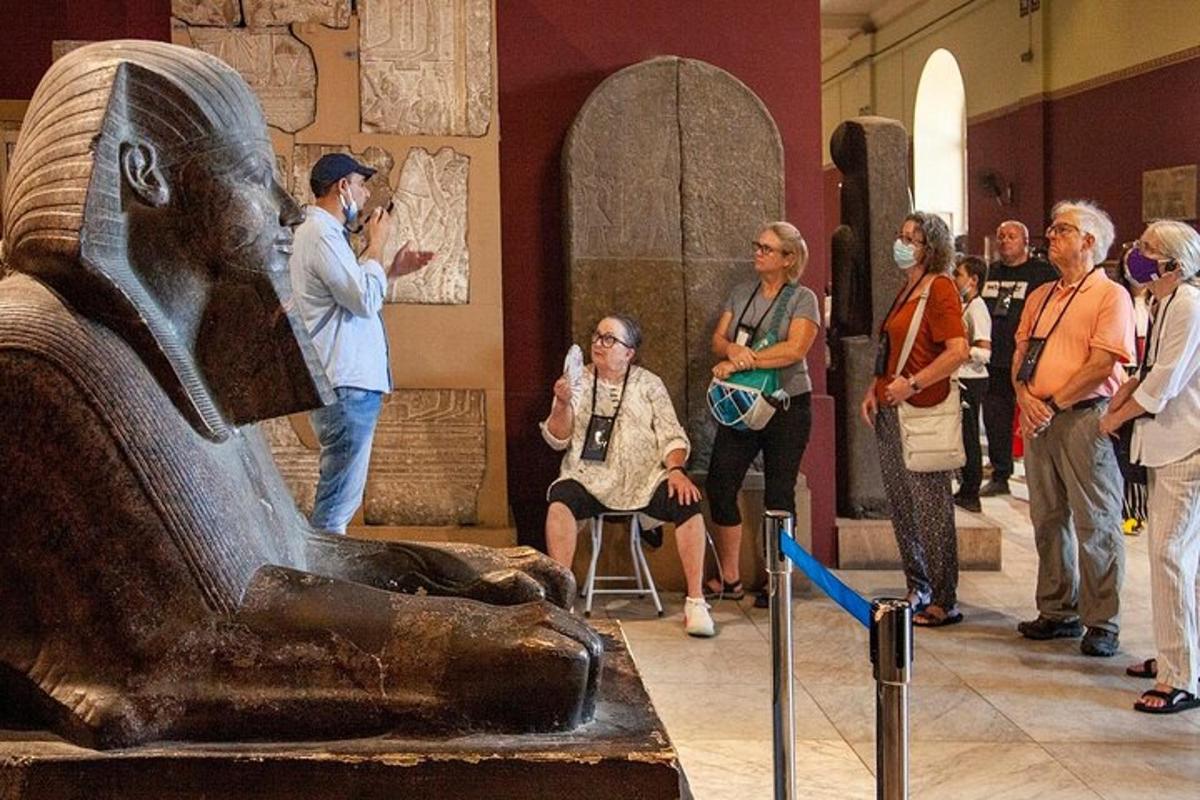 a group of people looking at a statue in a museum