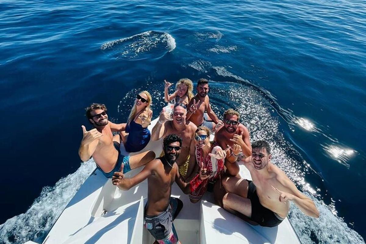a group of people on a boat in the ocean