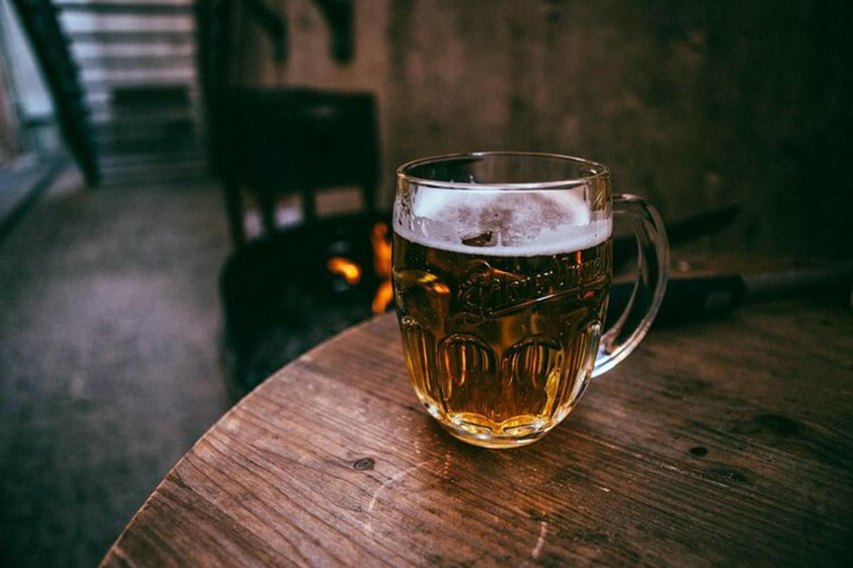 ein Glas Bier auf einem Holztisch