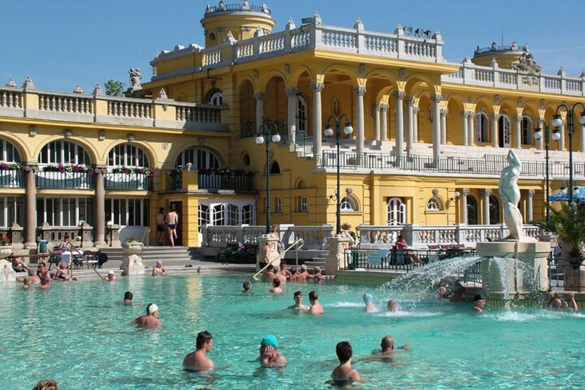 a group of people in a pool in front of a building